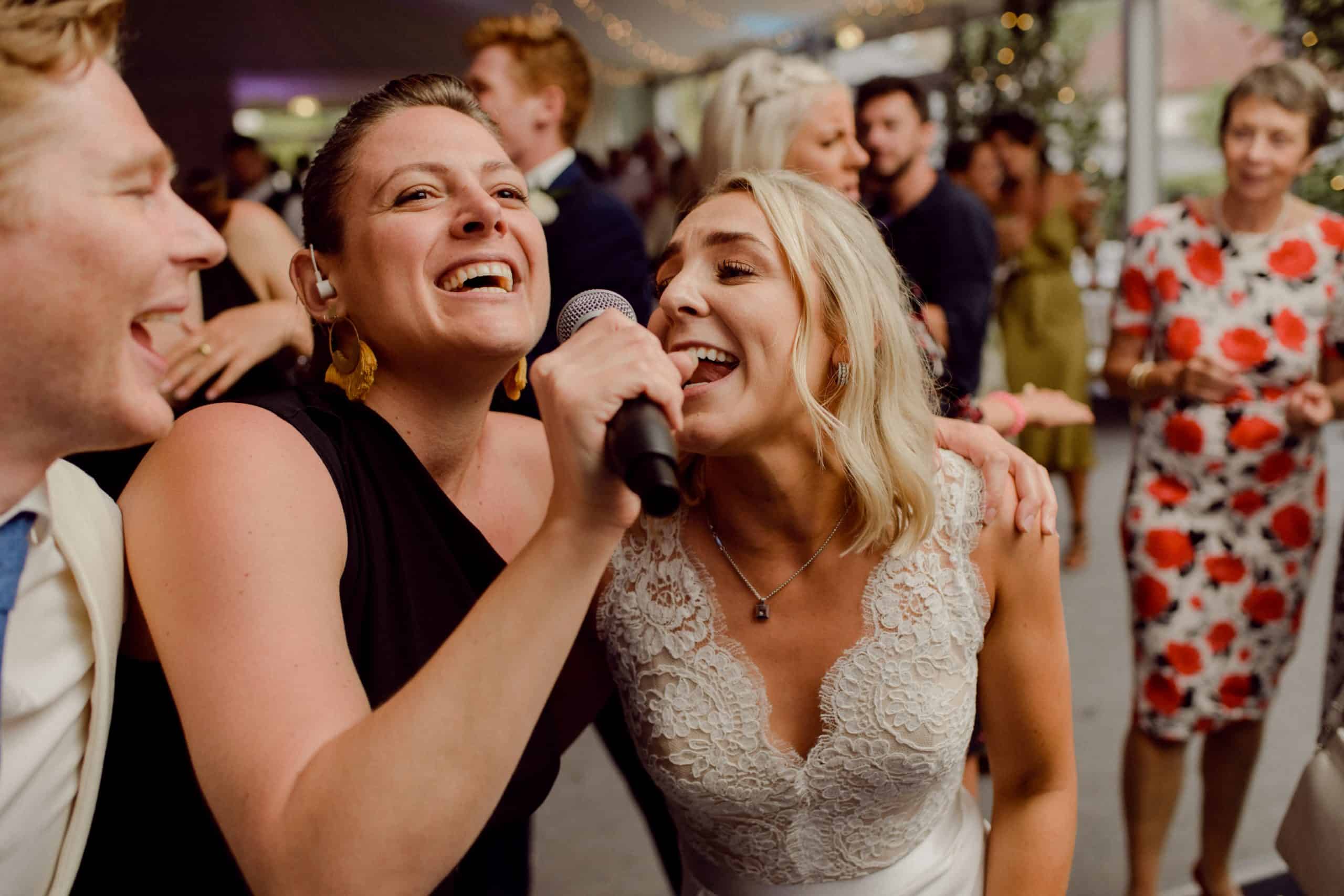 Bride and groom's first dance surrounded by guests