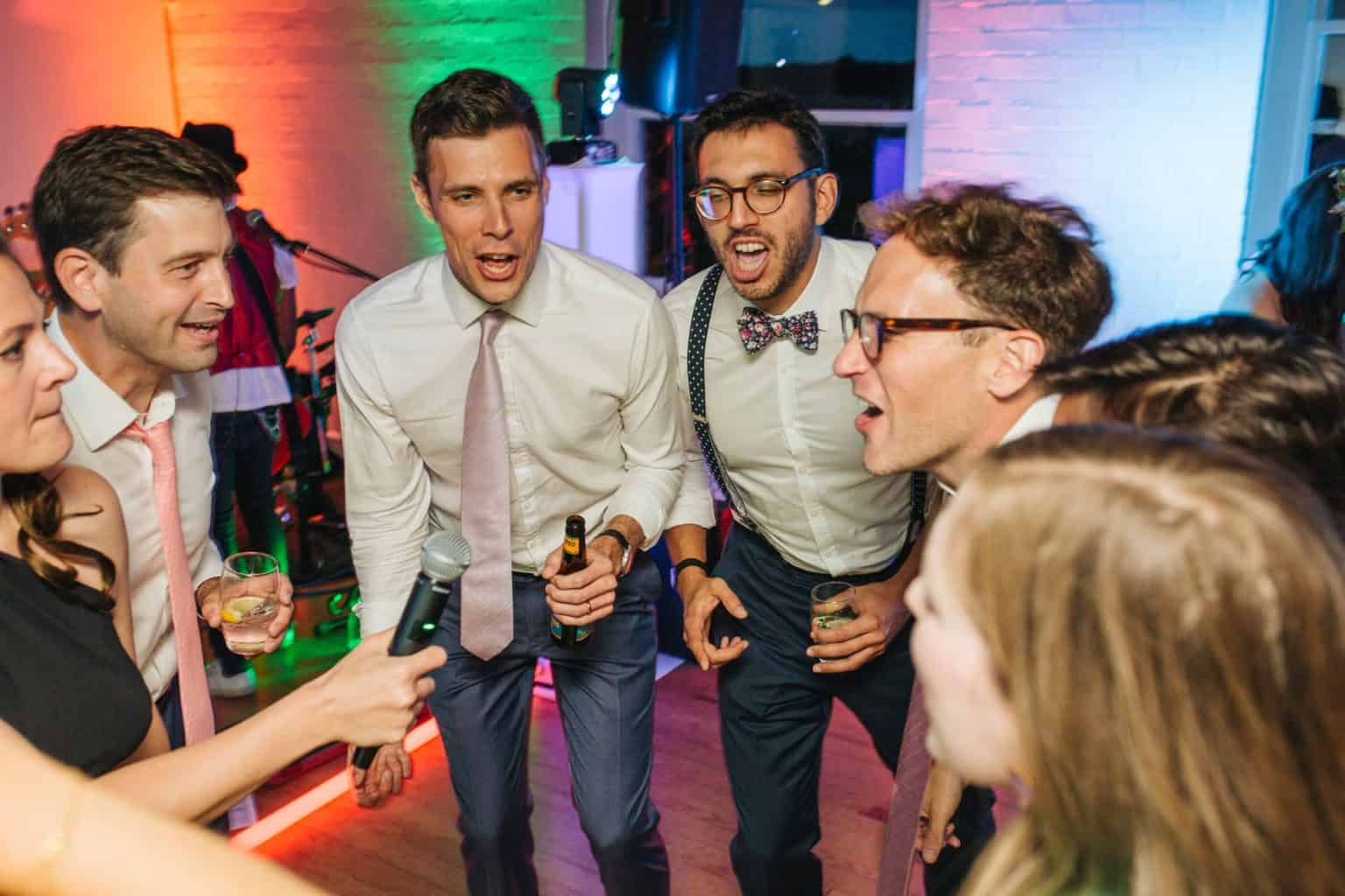 A packed dance floor at an evening reception